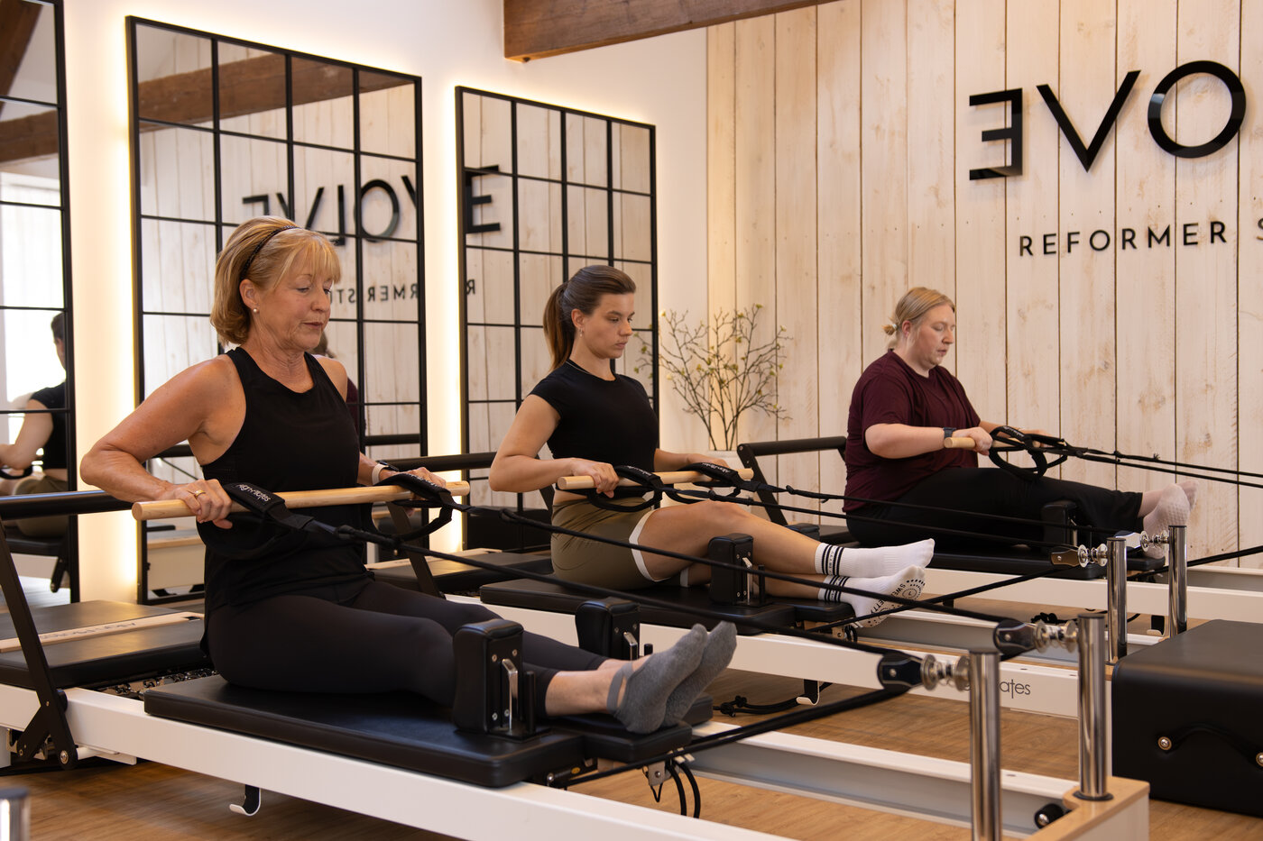 Clients training together on the reformers at EVOLVE